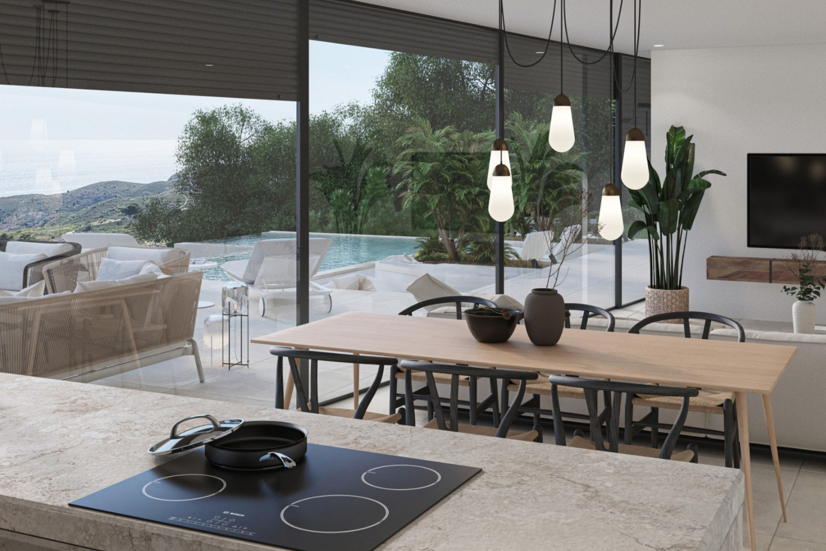 Open leefruimte met natuurstenen kookeiland, design hanglampen en kamerhoge schuifdeuren die toegang bieden tot het terras met overloopzwembad en zeezicht.