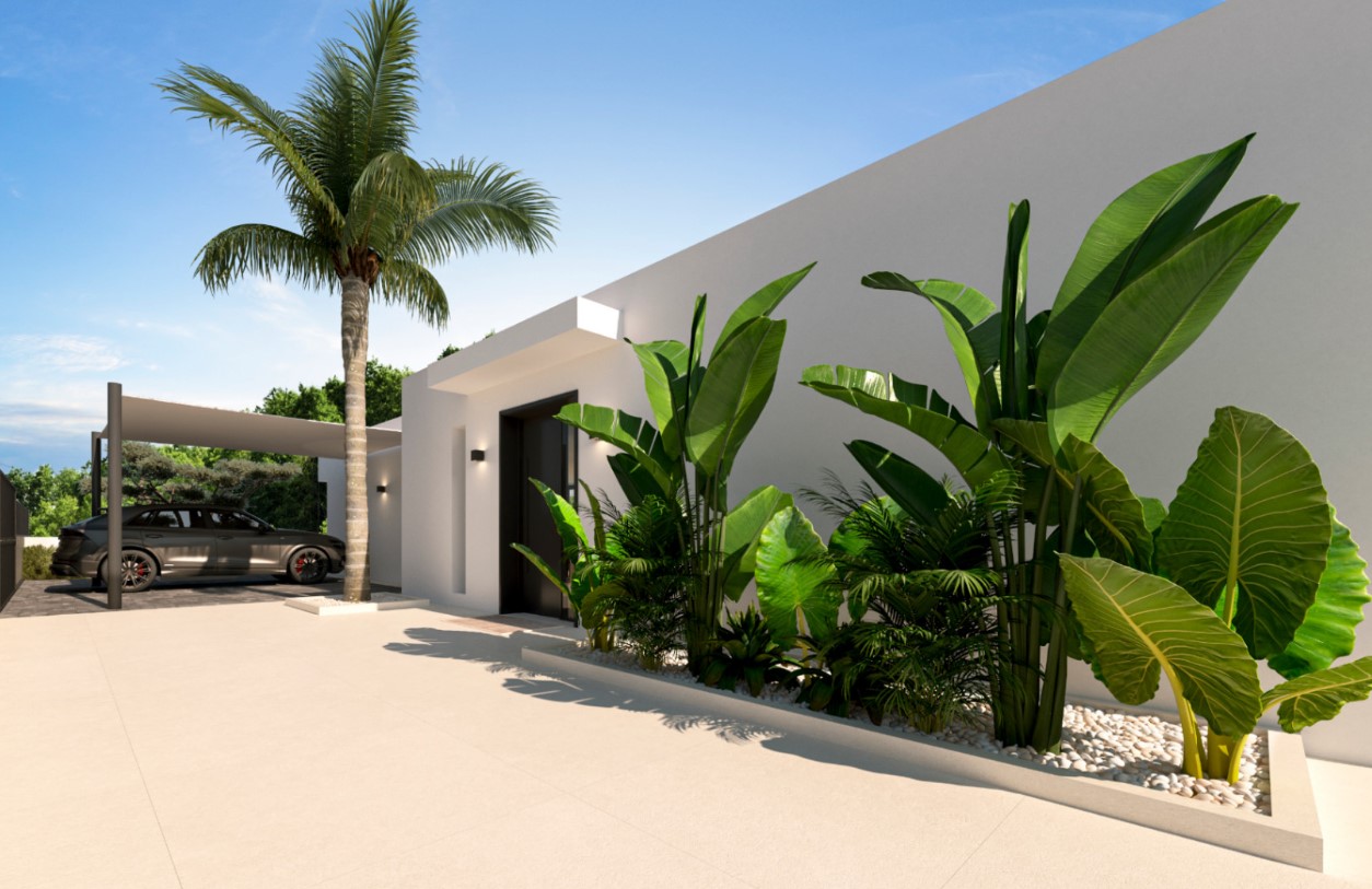Hoofdingang met een minimalistisch ontwerp, donkere deur en witte plantenbakken met tropische vegetatie. Een overdekte carport bevindt zich naast de villa.