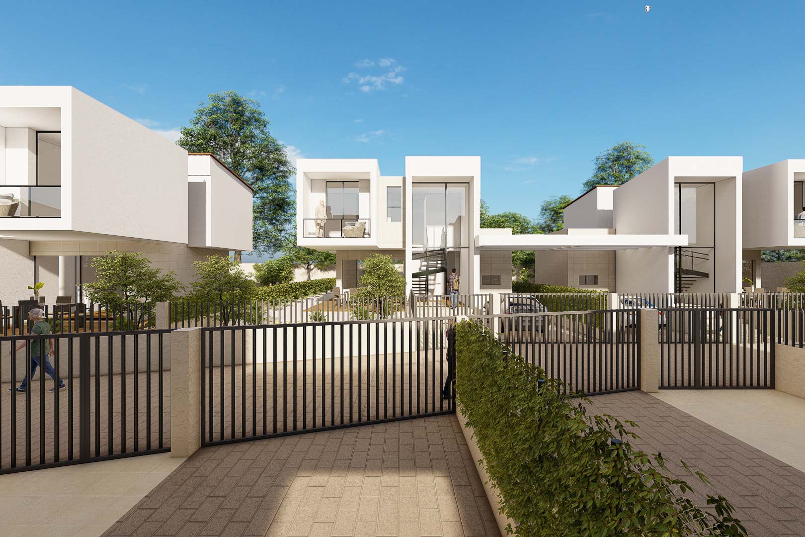 Buitenaanzicht van de moderne witte villa's met kubistische vormen en grote glaspartijen. De bestrate oprit en het zwarte hekwerk zorgen voor een strakke, moderne afwerking.