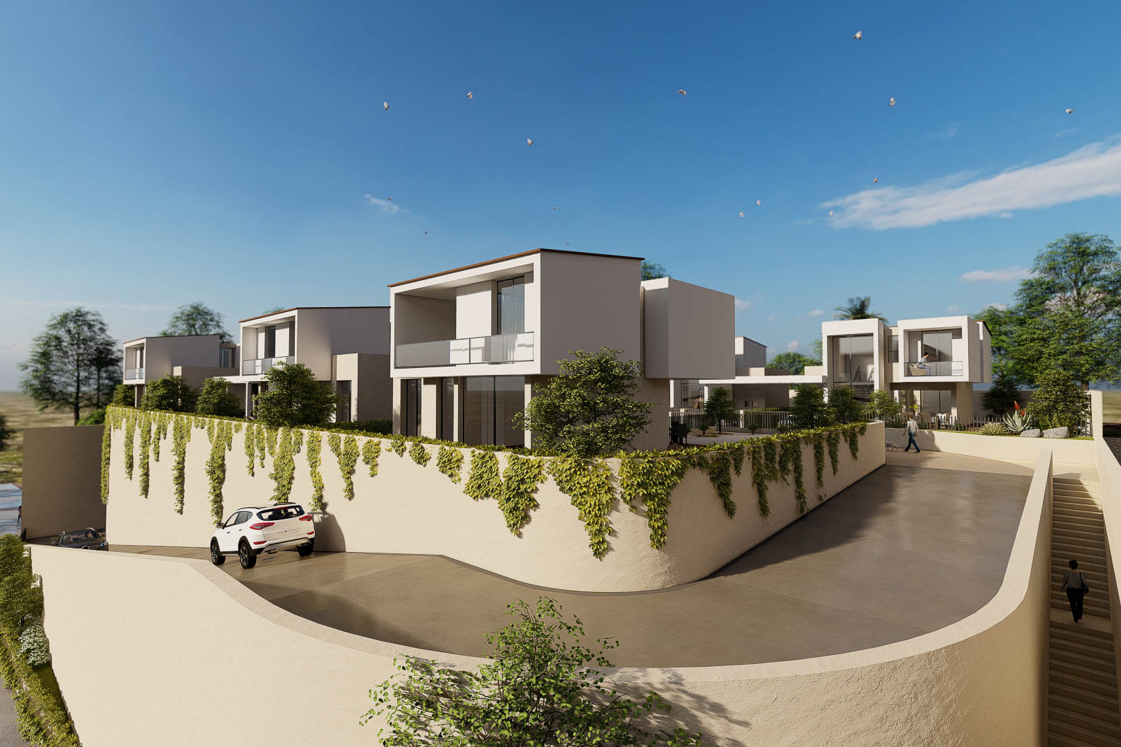 Exterieur van het wooncomplex met kubistische villa's, glazen balkons en met klimop begroeide muren langs de verharde oprit op een hellend terrein.