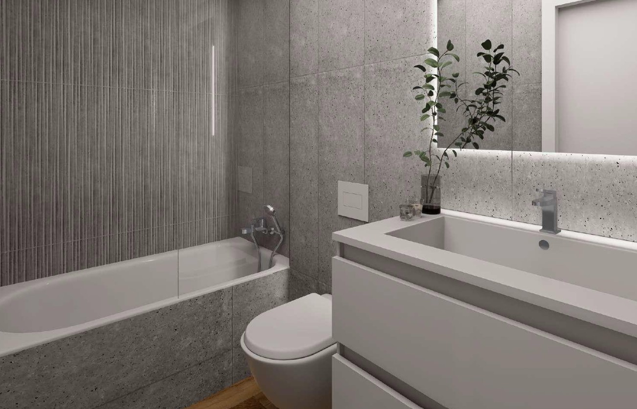 Moderne badkamer met grijze Porcelanosa tegels, een ingebouwd ligbad met glazen wand en een strak wastafelmeubel met indirecte LED-spiegelverlichting.