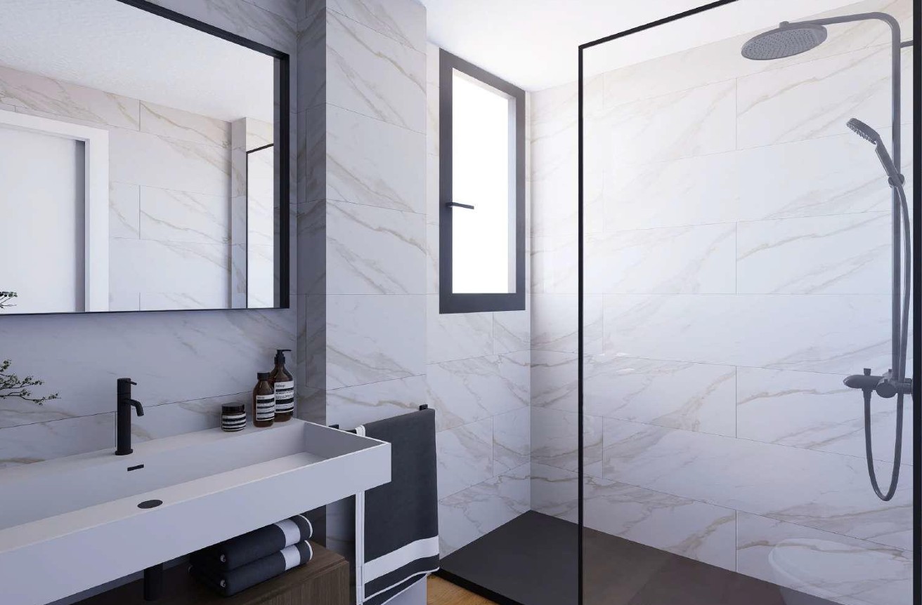 Moderne badkamer met Porcelanosa tegels in marmerlook, een inloopdouche met zwart profiel en een geïntegreerde wastafel met matzwarte kranen.