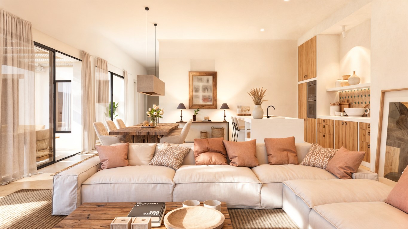 Open woonkamer met modulaire bank, massief houten eettafel en moderne keuken met wit eiland, verbonden met het terras via grote glazen schuifdeuren.