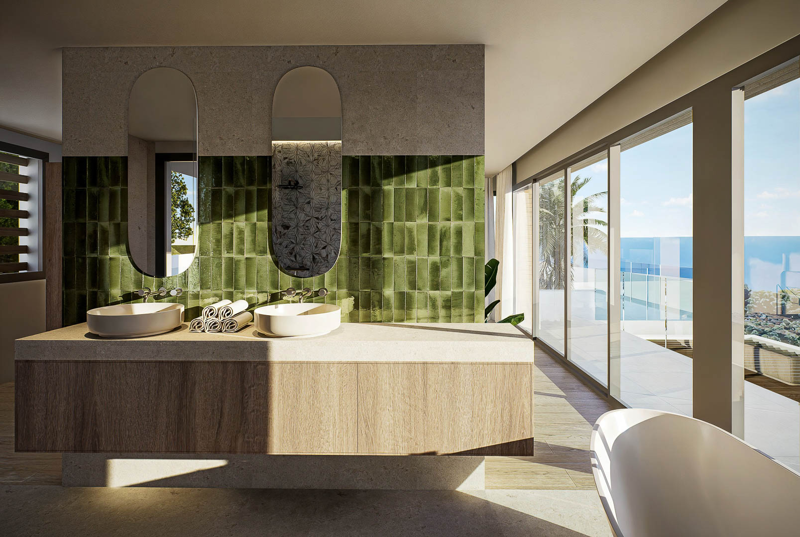 Hoofdbadkamer met dubbele wastafel, groene verticale tegels en kamerhoge ramen met panoramisch uitzicht op zee en toegang tot het terras.