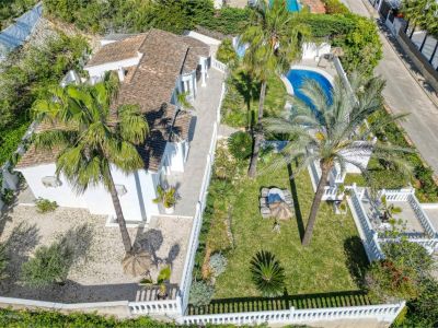 Luchtfoto van de villa met tuin, zwembad en terras. Mediterraan ontwerp met witte muren en weelderig groen.