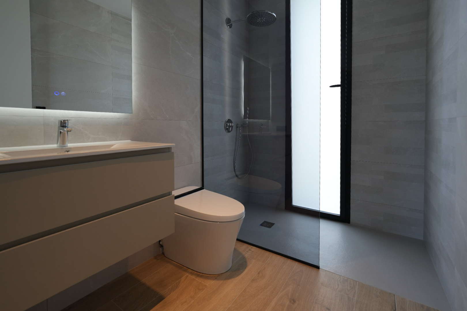 Moderne badkamer met zwevend wastafelmeubel, verlichte spiegel, wandcloset en inloopdouche met regendouchekop, afgewerkt met grijze tegels en een houtlook vloer.
