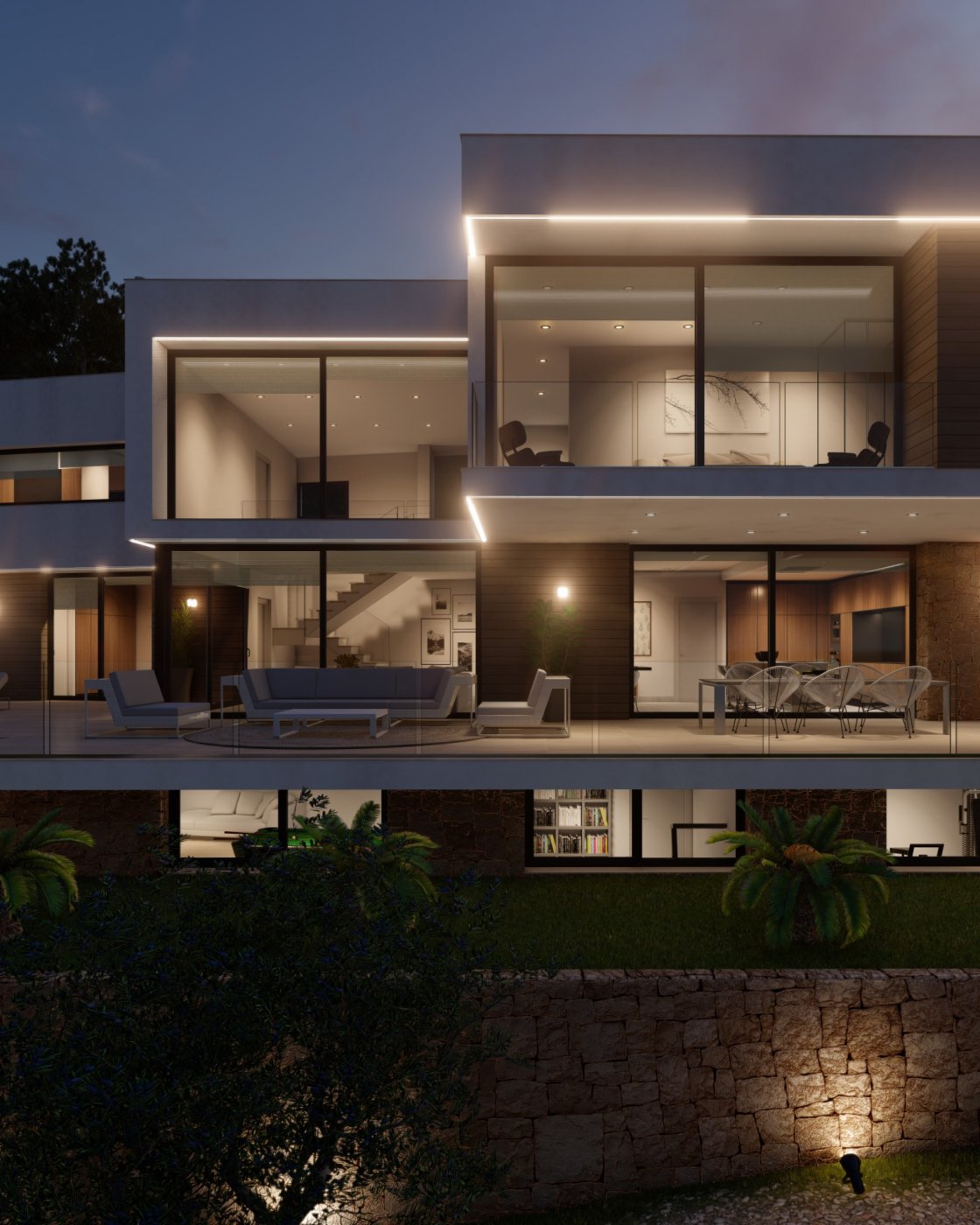 Moderne villafaçade bij avond met kamerhoge glaspartijen, geïntegreerde ledverlichting, een ruim terras met loungemeubilair en een natuurstenen muur.