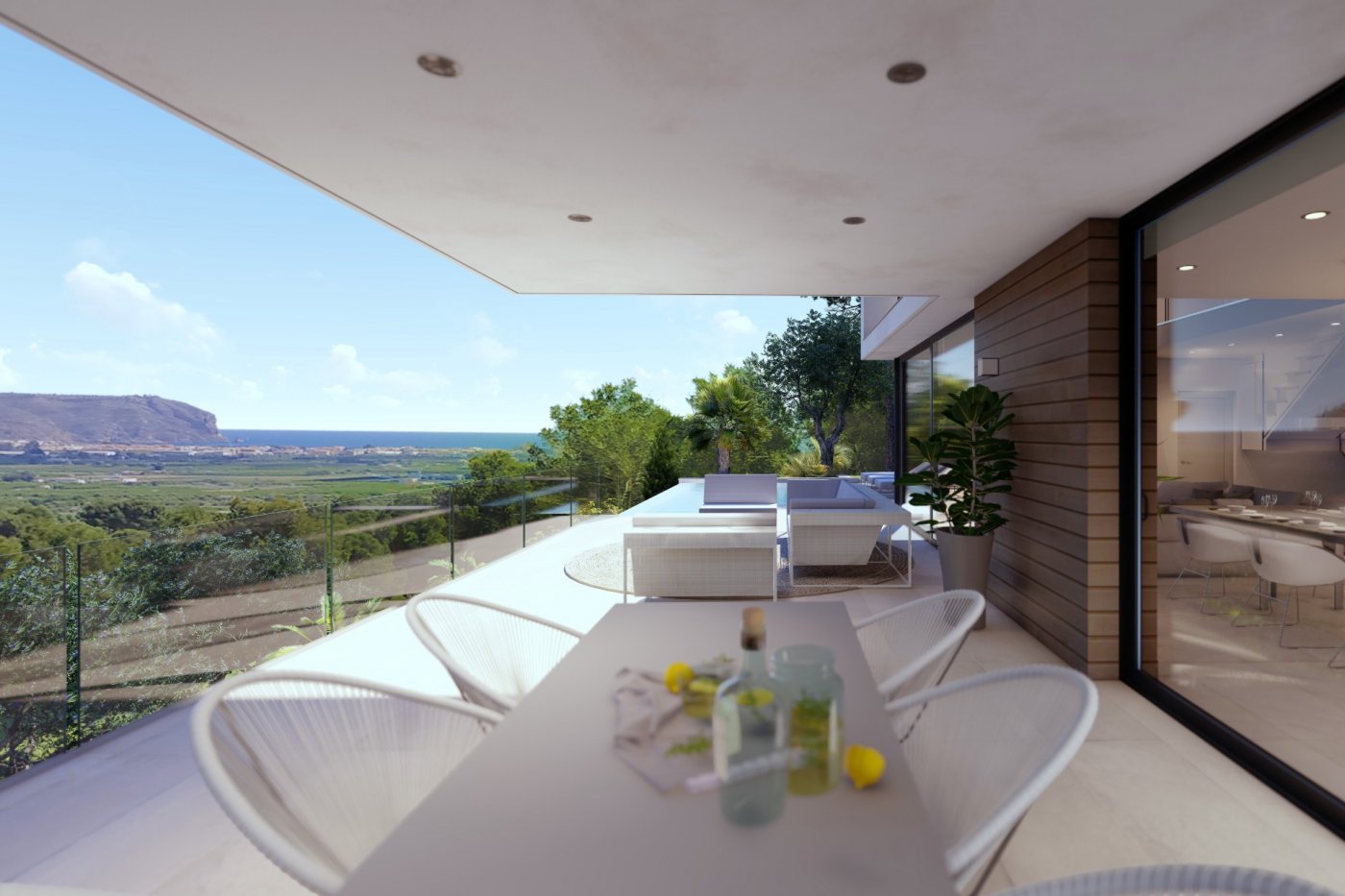 Overdekt terras met eethoek en lounge, glazen balustrades en panoramisch uitzicht over de vallei en de Middellandse Zeekust.