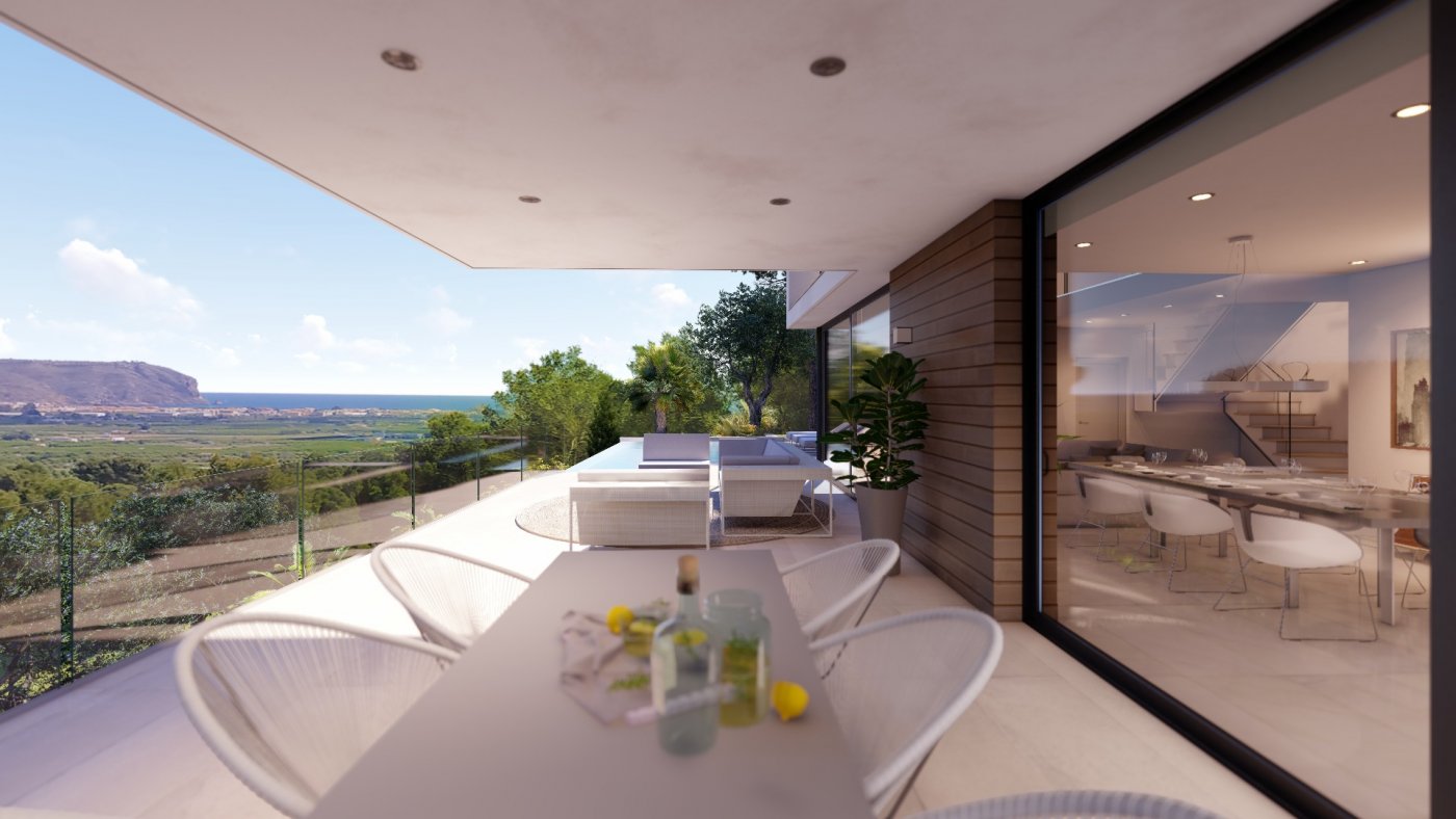 Overdekt terras met eethoek en lounge, voorzien van een glazen balustrade en panoramisch uitzicht over de vallei en de kustlijn.