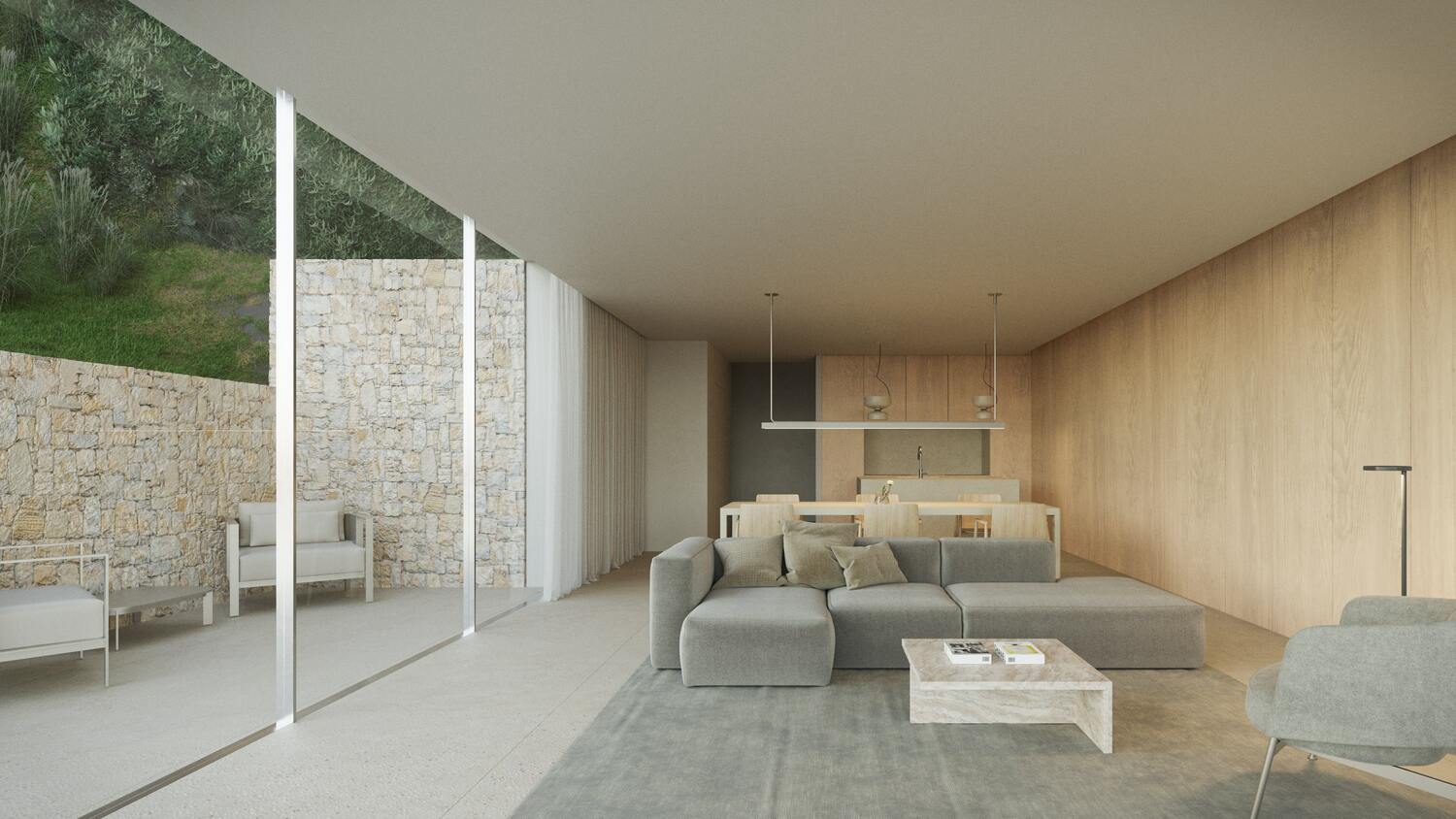 Open woonkamer met grijze hoekbank, licht houten wandpanelen en kamerhoge glazen deuren die toegang bieden tot een patio met natuurstenen muren.