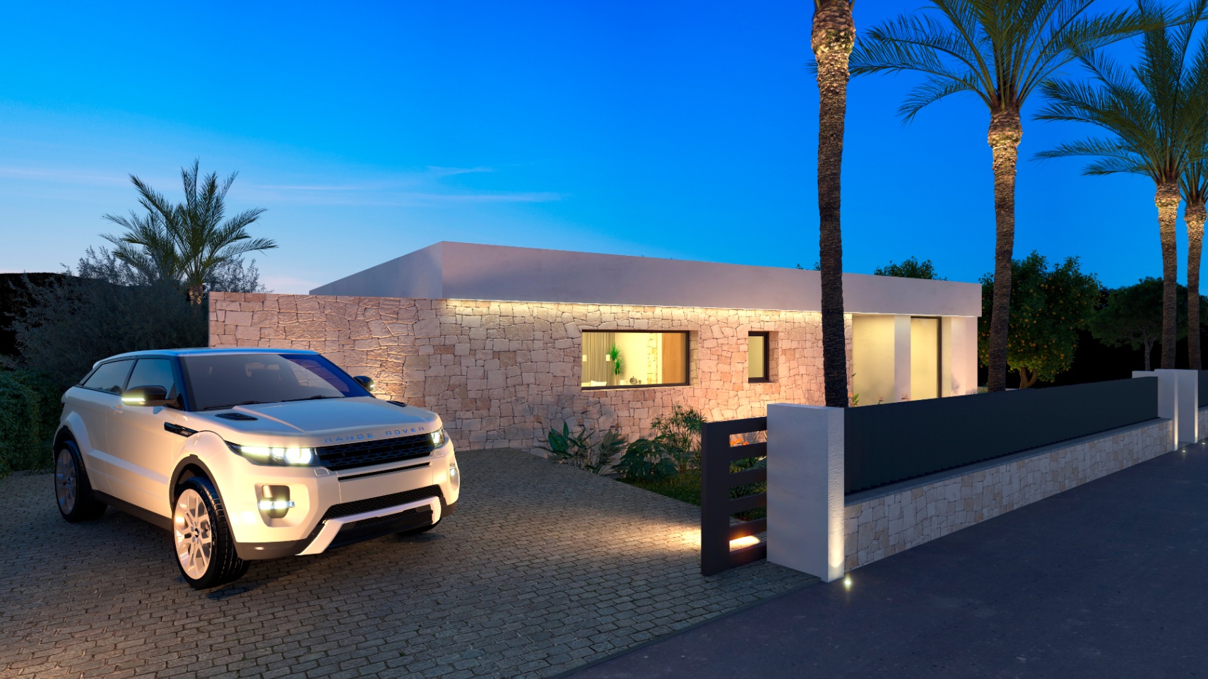 Buitenaanzicht van de villa met verlichte stenen gevel en een Range Rover op de oprit.