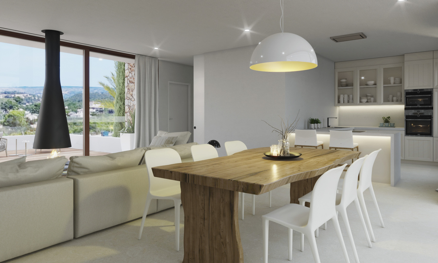 Open woonruimte met een massief houten eettafel, moderne hangende haard en een luxe keuken met uitzicht op het omliggende landschap en de bergen.