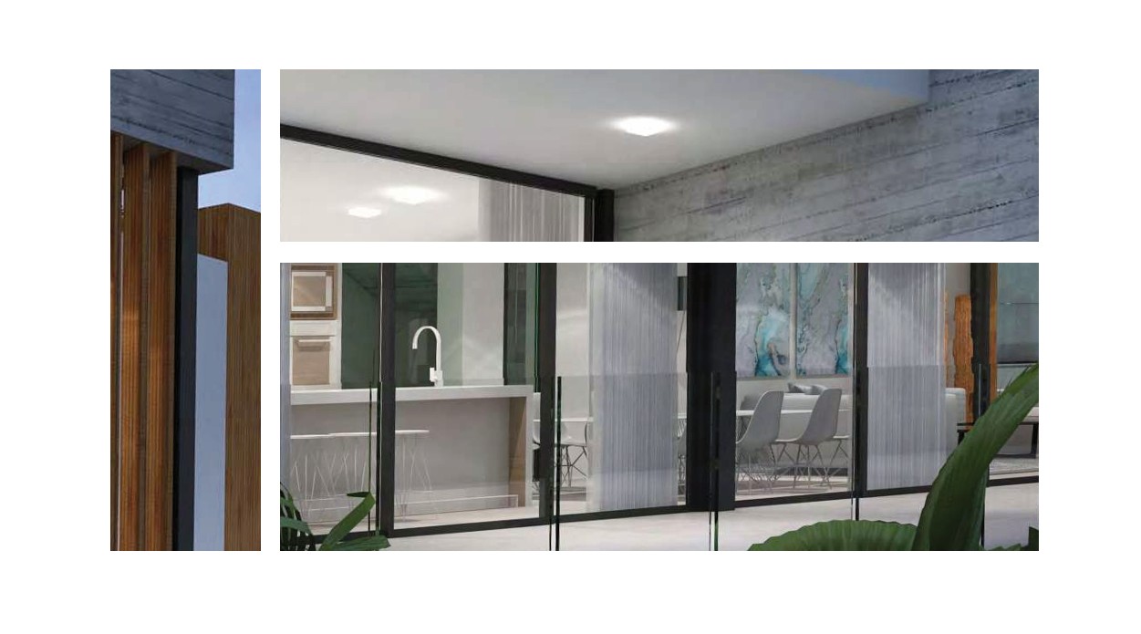 Buitenaanzicht van de begane grond met zicht op de moderne keuken met kookeiland en de eetkamer door grote glazen schuifdeuren en glazen balustrades.