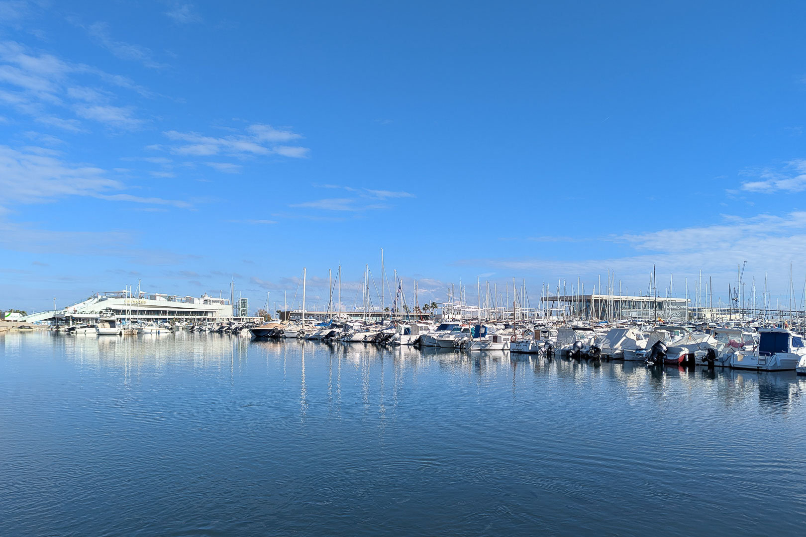 Uitzicht op de jachthaven met meerdere boten onder een helderblauwe hemel.