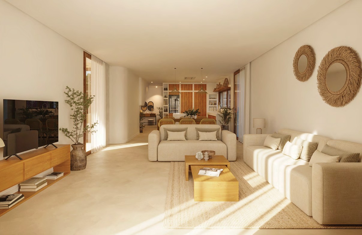Lichte woonkamer met beige banken, houten salontafel en natuurlijke decoratie.