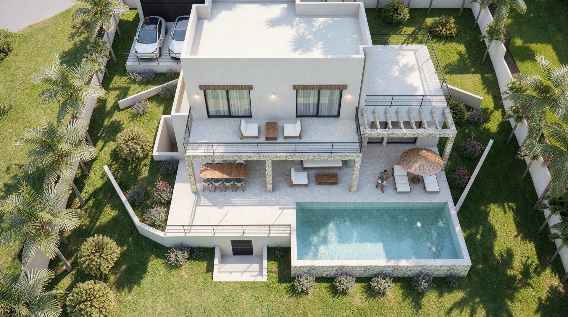 Luchtfoto van de moderne villa met rechthoekig zwembad, terrassen op twee niveaus met natuurstenen details en een tuin met palmbomen.