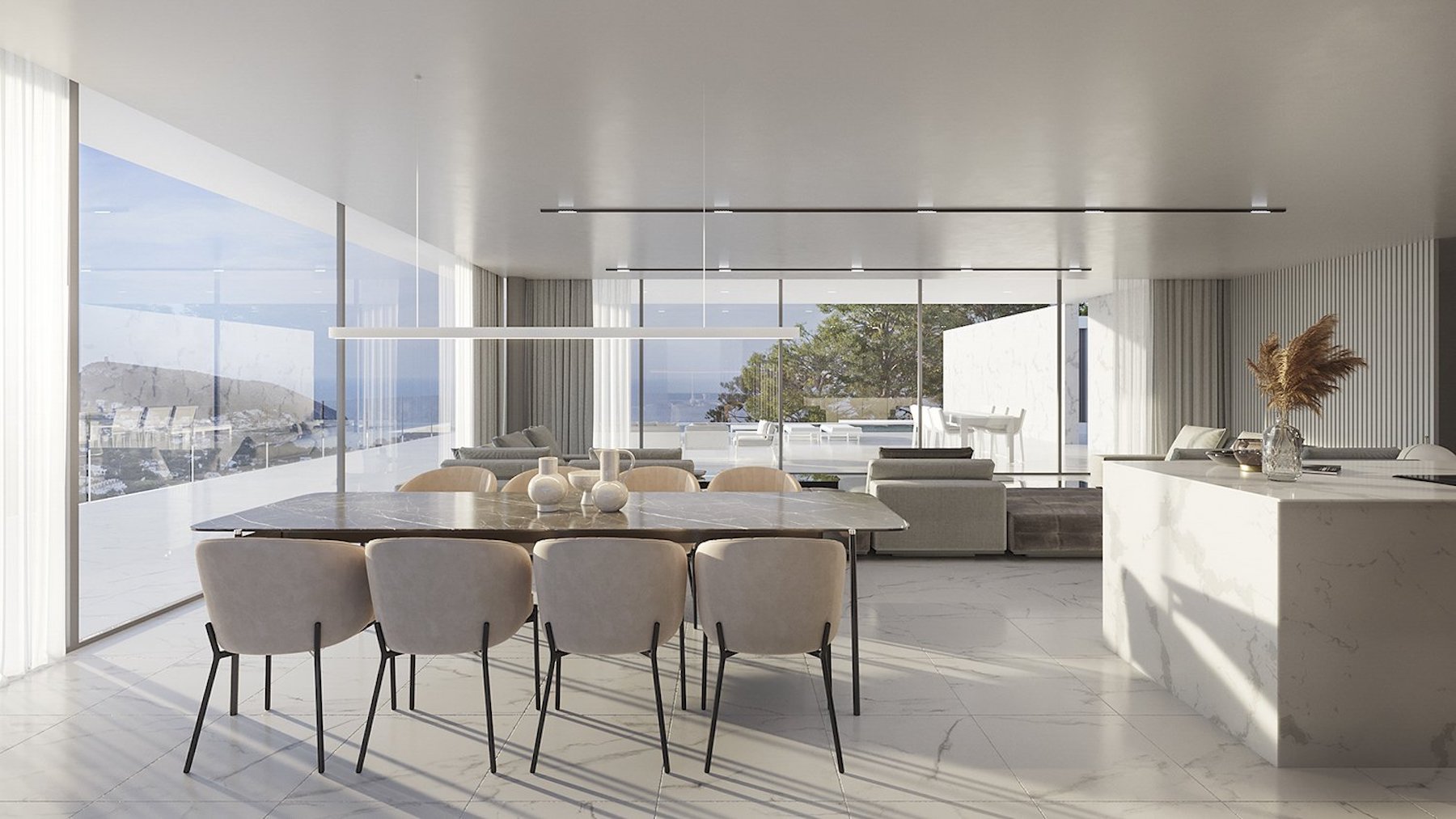Open woon- en eetkamer met een donker marmeren tafel, witstenen kookeiland en kamerhoge ramen met panoramisch uitzicht op de kust.