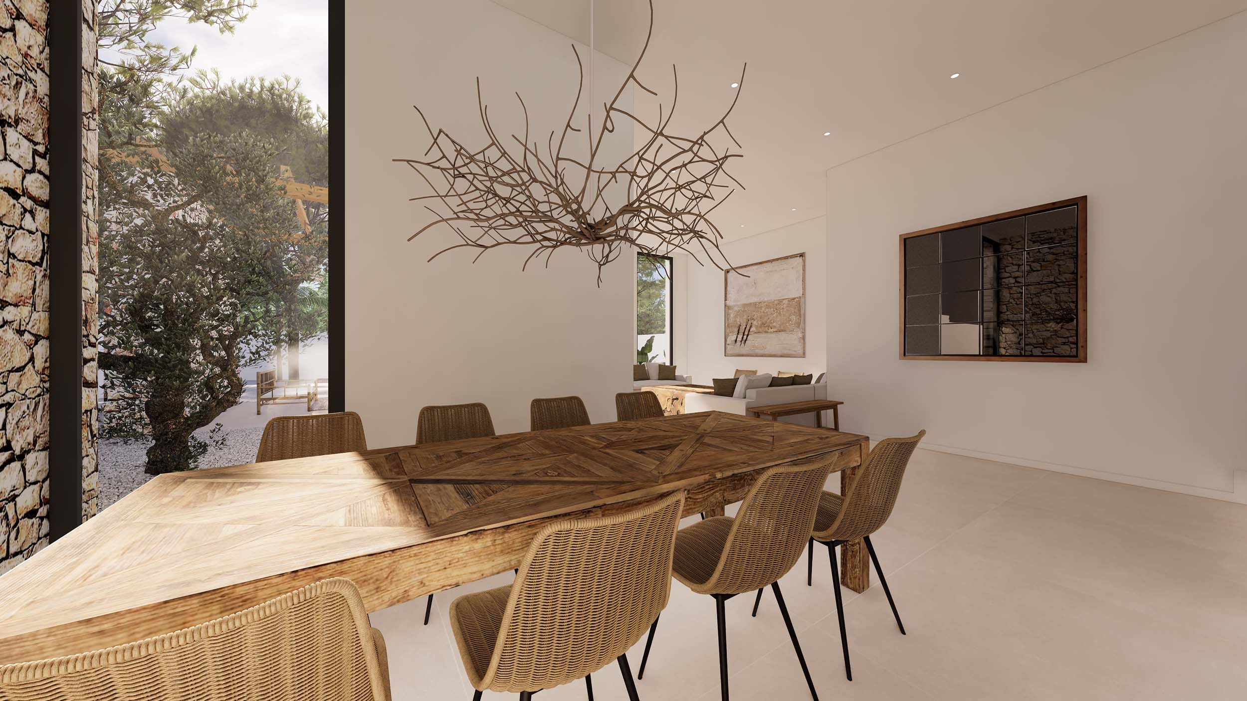Eethoek in Ibiza-stijl met een rustieke houten tafel en rieten stoelen. Voorzien van een sculpturale takkenkroonluchter en grote ramen met uitzicht op de tuin en de natuurstenen muur.