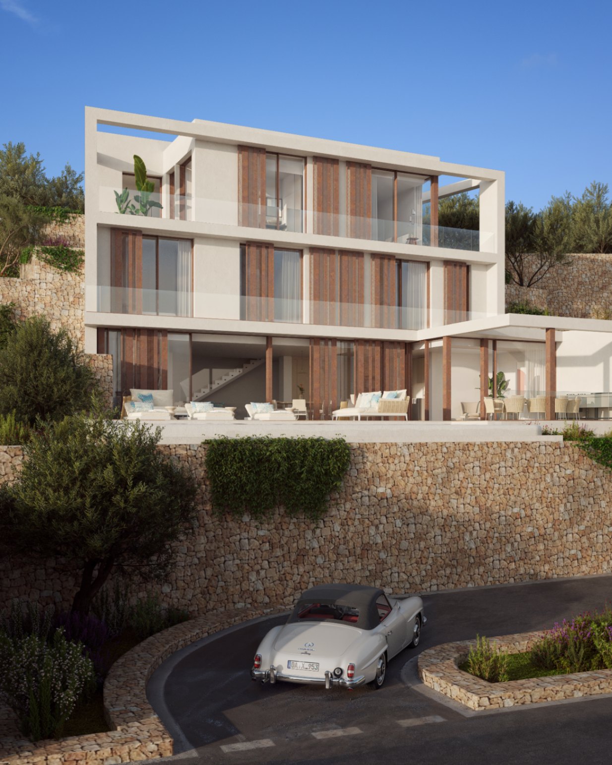 Gevel van drie verdiepingen met natuurstenen muren, houten lamellen en ruime glazen balkons. De buitenruimte is voorzien van een loungeterras en mediterrane beplanting op een helling.