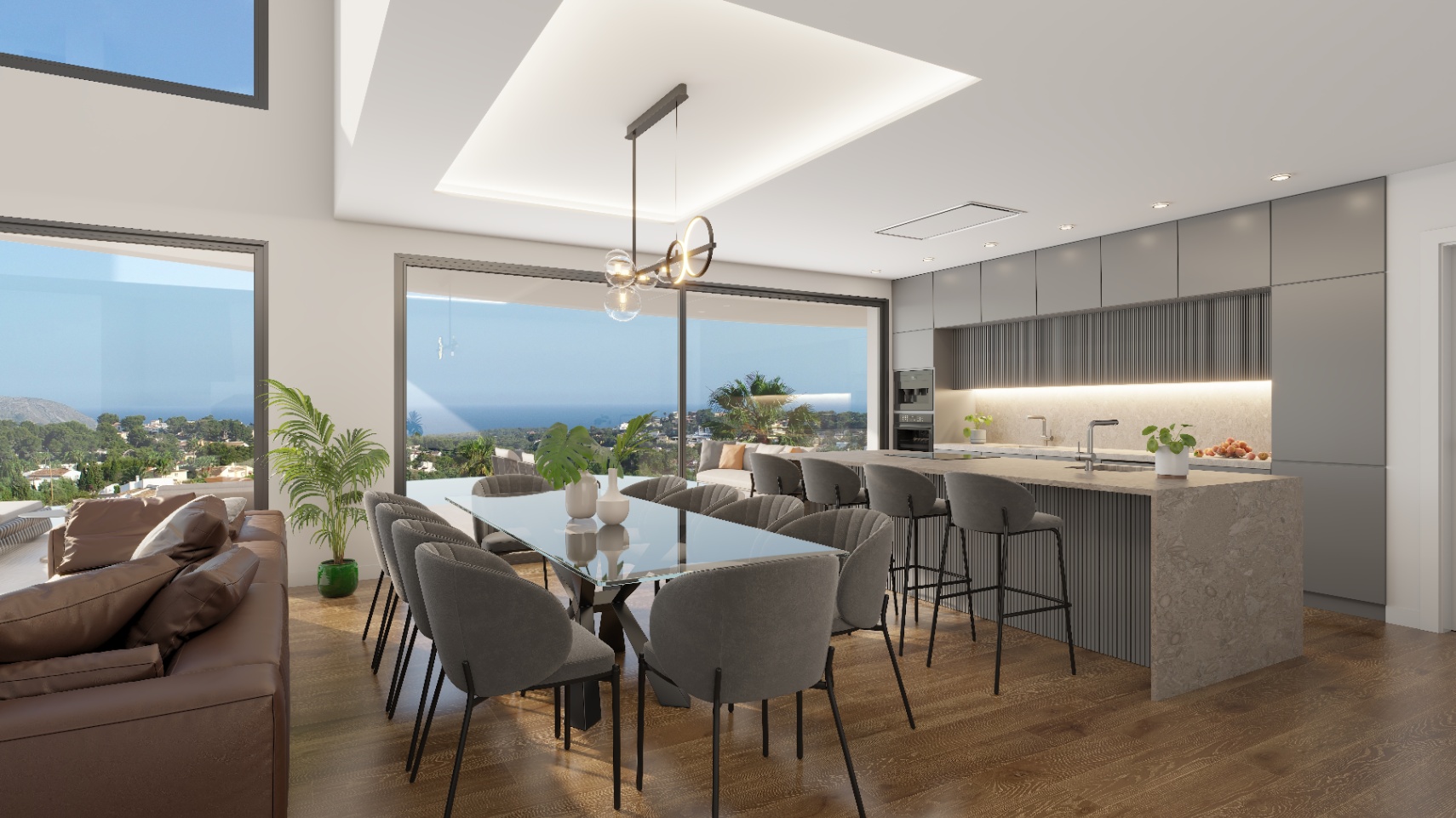Open woonruimte met een glazen eettafel en een moderne keuken met kookeiland. Grote glazen schuifdeuren bieden een panoramisch uitzicht op de Middellandse Zee.