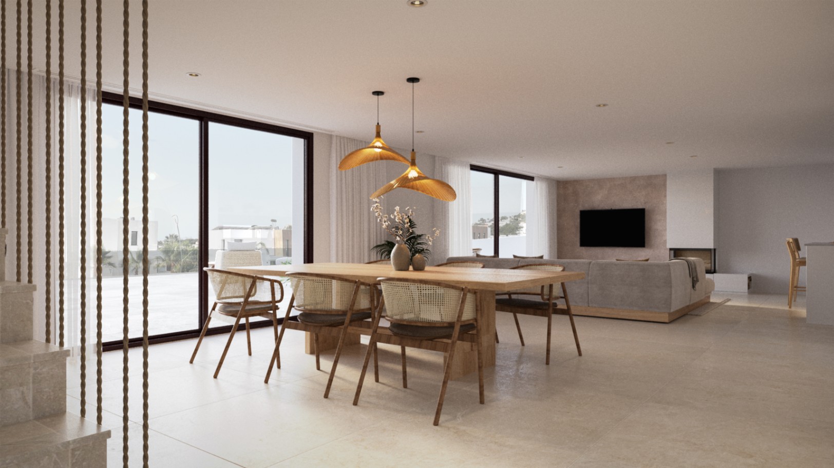 Open woon- en eetkamer met een massief houten tafel, rotan stoelen en organische hanglampen. Grote schuifdeuren bieden directe toegang tot het aangrenzende terras.