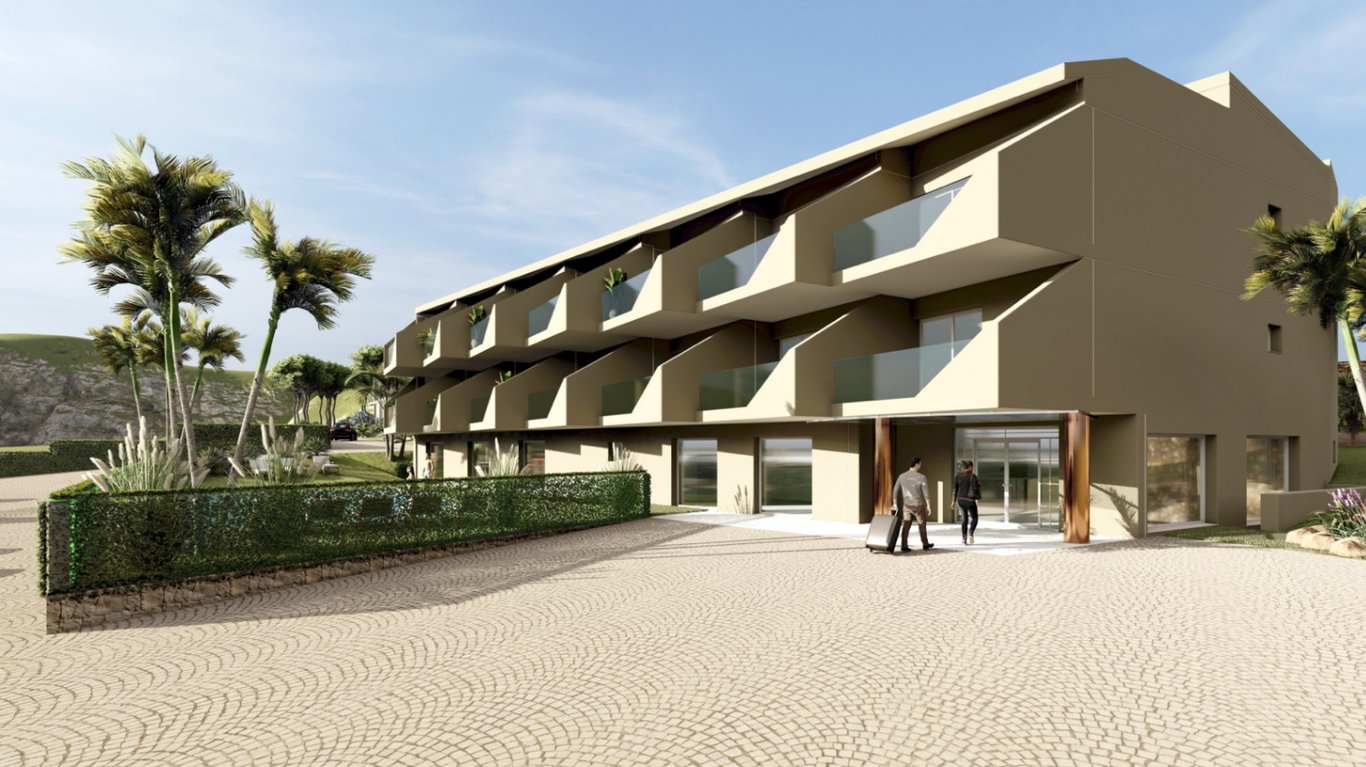 Buitengevel van het boetiekhotel met glazen privébalkons, een glazen hoofdingang en een geplaveid voorplein omgeven door mediterrane beplanting.