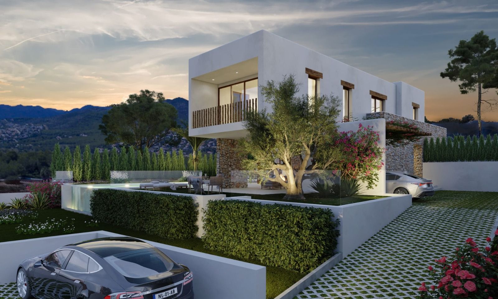 Buitenaanzicht van de villa in Ibiza-stijl bij schemering, met witte gevels, natuurstenen muren, een boventerras en een mediterrane tuin met verlichte olijfboom.
