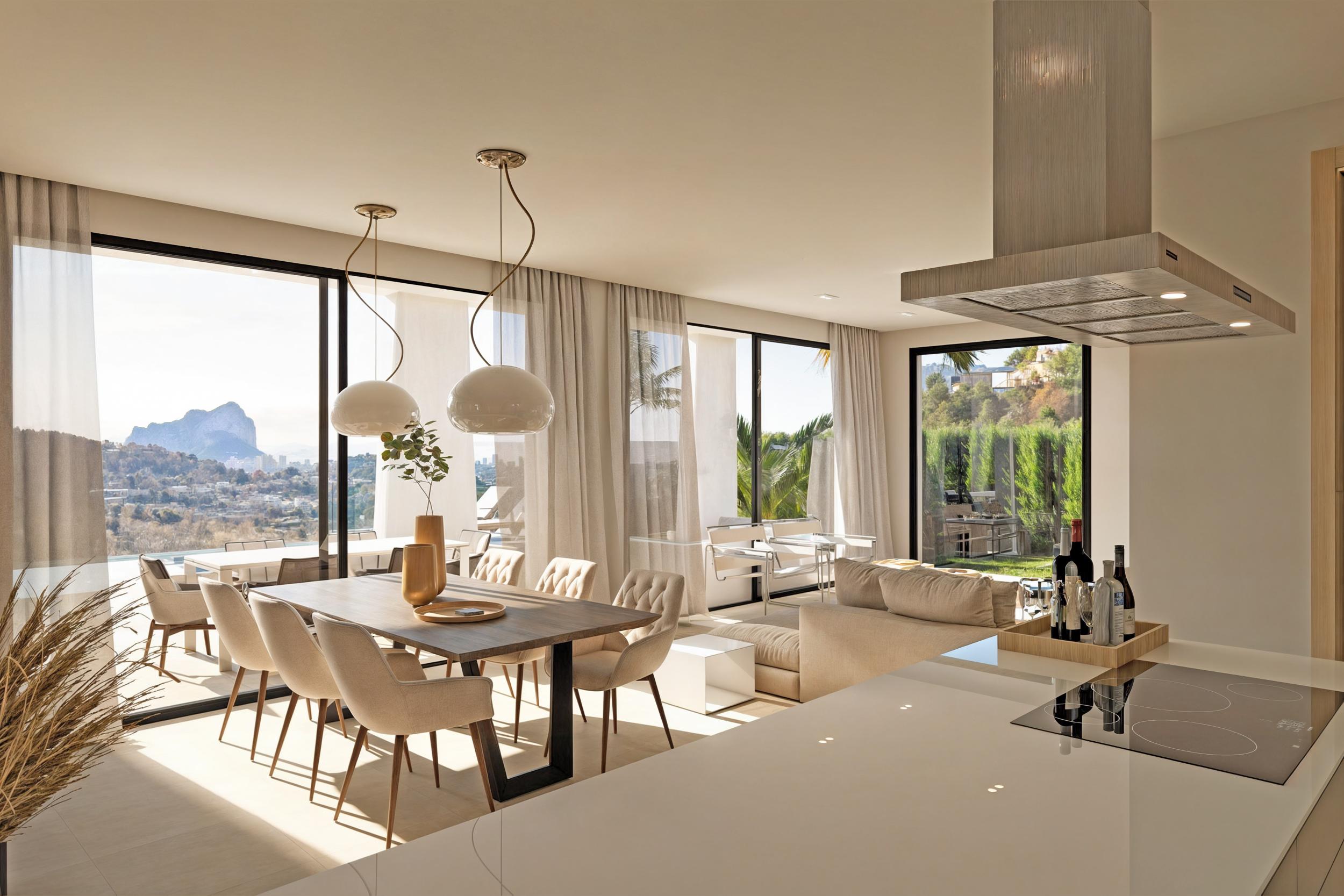 Lichte woon-eetkamer met houten tafel en uitzicht op de Peñón de Ifach.