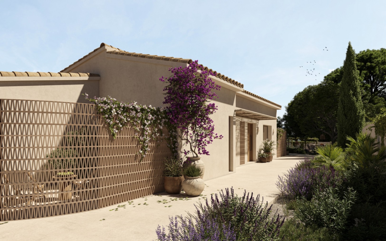 Buitengevel met decoratief terracotta vlechtwerk, bougainville in potten en een mediterrane tuin met lavendel langs de entree van de villa.