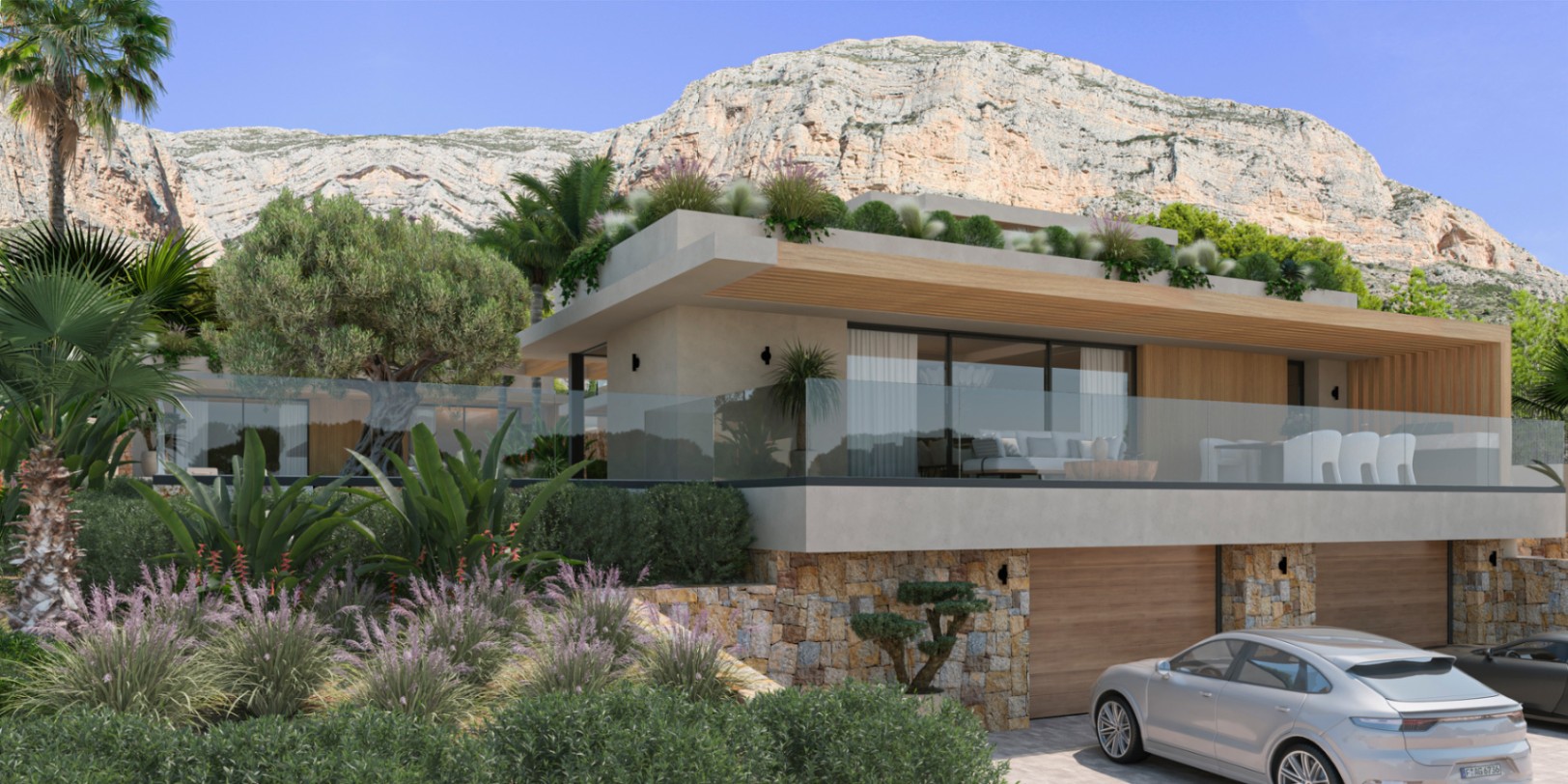 Exterieur van de villa met natuurstenen gevel en houten accenten aan de voet van de Montgó. Voorzien van een glazen terras en een dubbele garage op de begane grond.