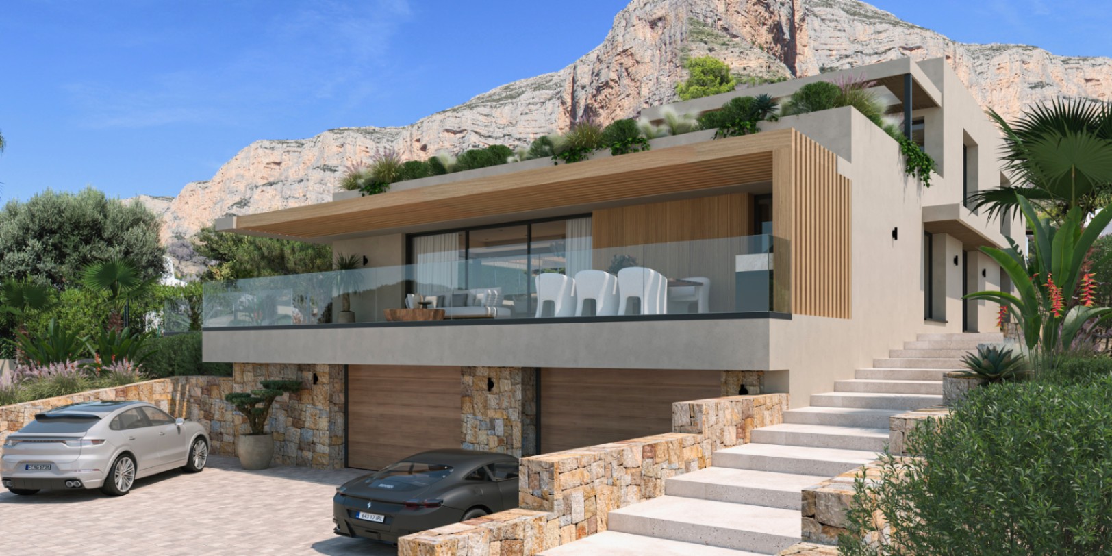 Moderne gevel met natuurstenen muren, dubbele garage en een ruim terras met glazen balustrades tegen de achtergrond van de Montgó-berg.