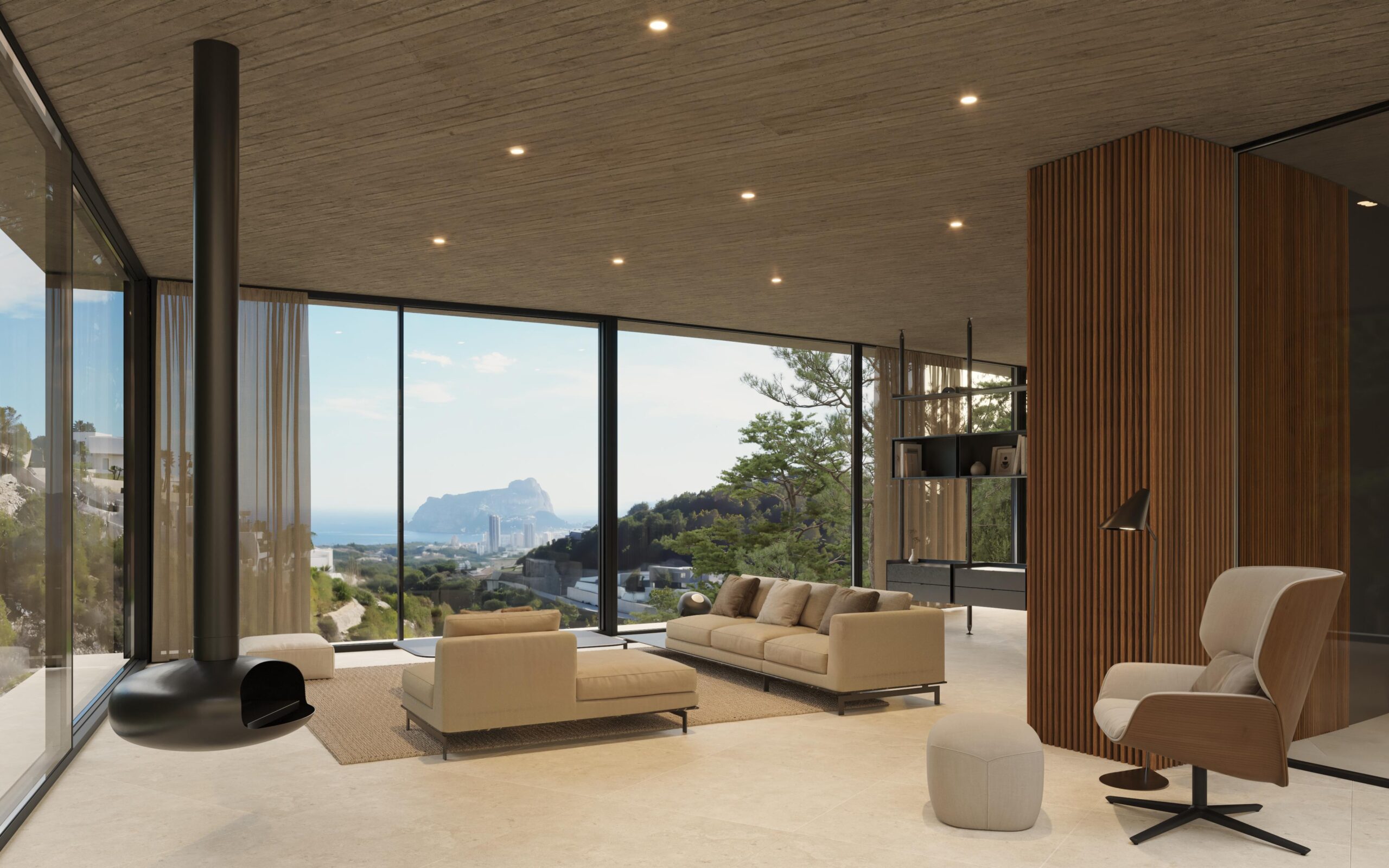 Moderne woonkamer met hangende haard, betonnen plafonds en kamerhoge ramen met panoramisch uitzicht op de Middellandse Zeekust en de Peñón de Ifach.