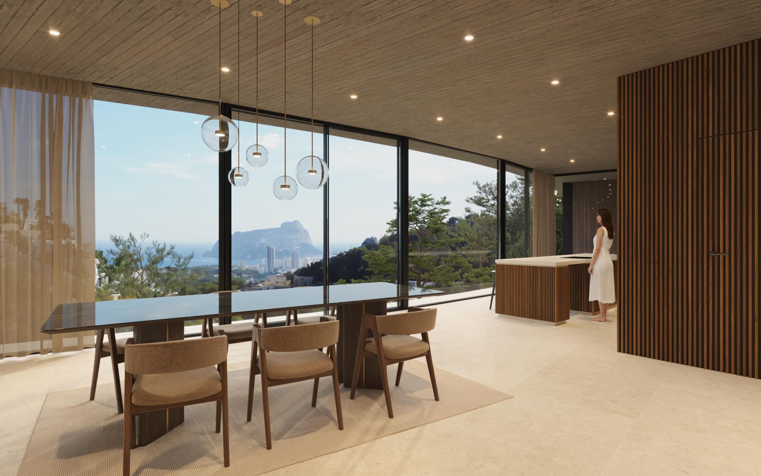 Open eetruimte met een zwarte marmeren tafel, glazen hanglampen en kamerhoge ramen met panoramisch uitzicht op de Peñón de Ifach en de Middellandse Zeekust.