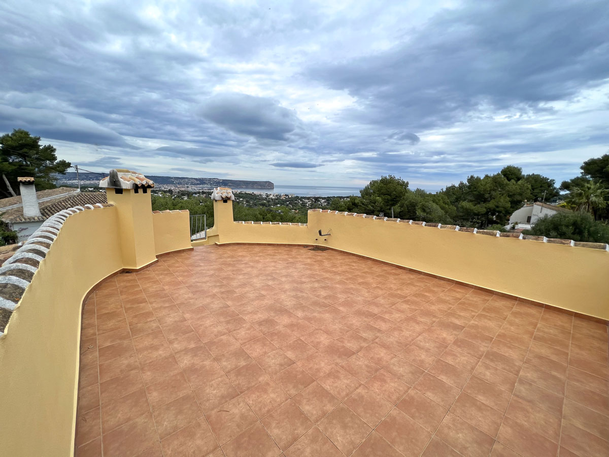 Ruim dakterras met terracotta-stijl tegels en een gebogen ommuring, met panoramisch uitzicht over de Middellandse Zee en Cabo San Antonio.