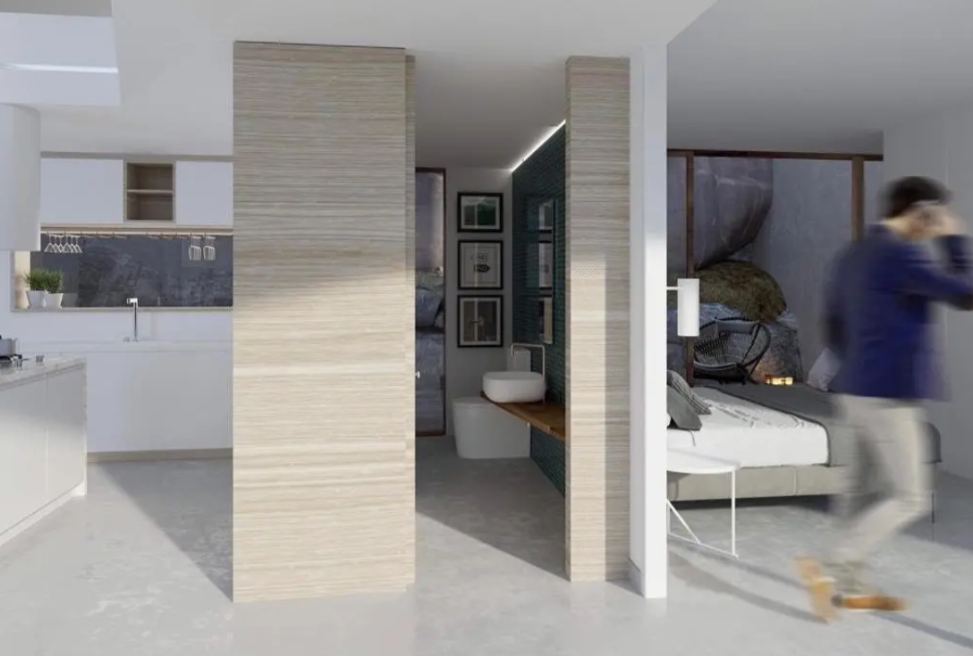 Open suite met geïntegreerde witte keuken, en-suite badkamer met opzetwastafel en slaapkamer met uitzicht op een rotswand. Scheidingswanden in lichte houtlook.